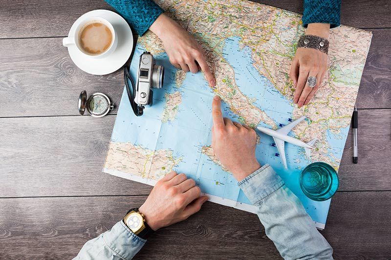 Two people planning a vacation using a map